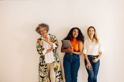 Three happy businesswomen laughing together