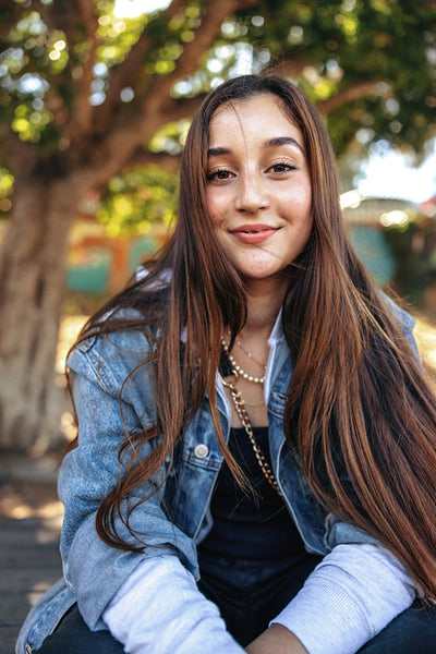 Cute teenage girl looking at the camera outdoors