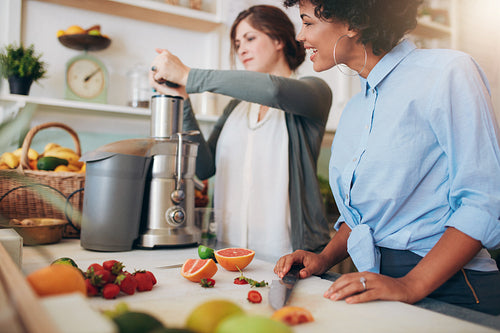 Juice bar employees preparing fresh fruit juices