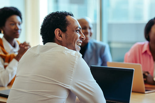 Smiling professionals engaged in a positive business meeting in a modern office setting