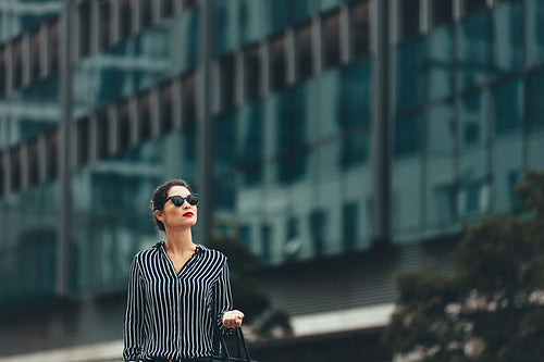 Female business professional outside an office building