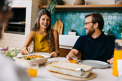Married couple enjoys a warm lunch together with family