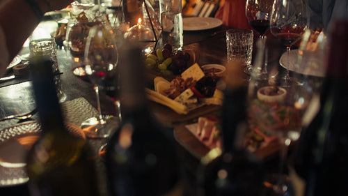 Friends enjoy a private wine tasting experience, toasting with red wine in a rustic cellar setting