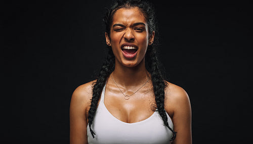 Portrait of fit woman making faces