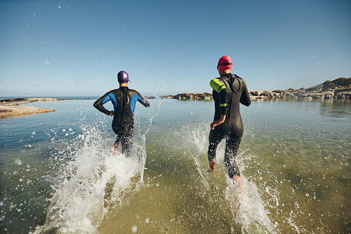 Two athletes competing in a triathlon