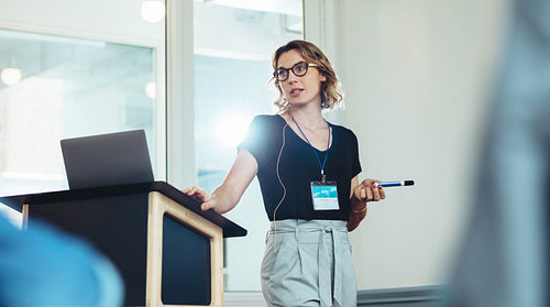 Businesswoman speaking from a podium in a seminar