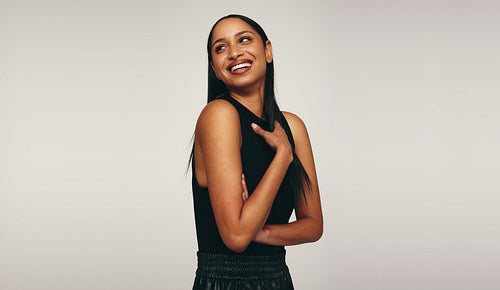 Young woman laughing cheerfully in a studio