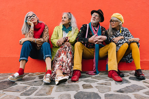 Elderly people looking thoughtful while sitting together