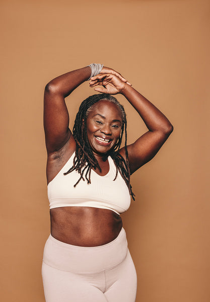 Happy mature woman smiling at the camera in sportswear