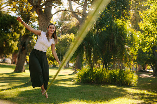 Woman walking on rope in a park