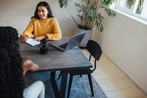 Young female architects in a modern workspace having a productive discussion.