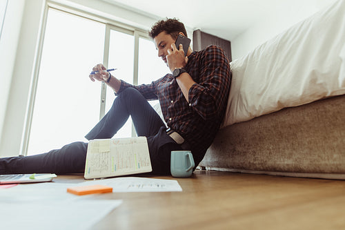 Man taking a phone call while working from home