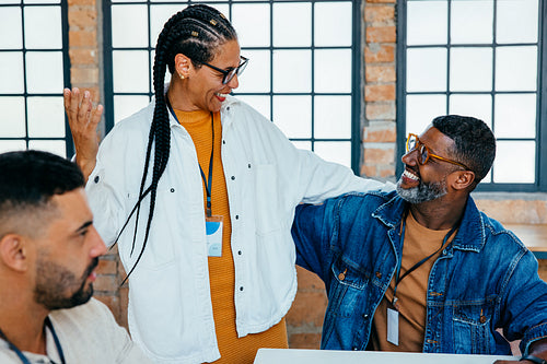 Colleagues celebrating success and fostering friendships in a vibrant workplace environment