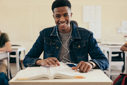 Smiling male student in university classroom