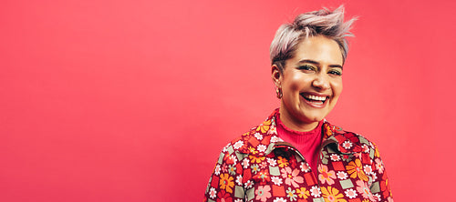 Happy hipster woman smiling at the camera in a studio