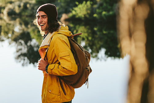 Tourist man walking beside a lake