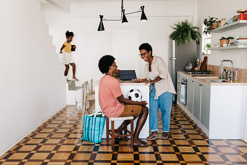 Happy family time in a Brazilian home: Mother and son chatting and smiling in the kitchen