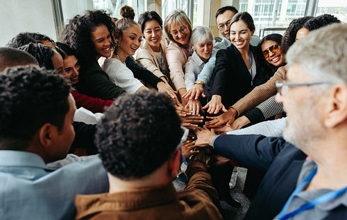 Diverse colleagues showing teamwork and unity during corporate teambuilding conference