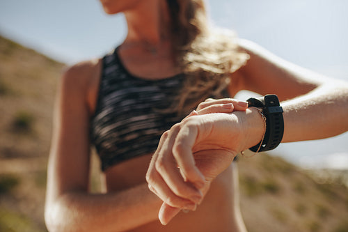 Runner checking fitness progress on her smart watch