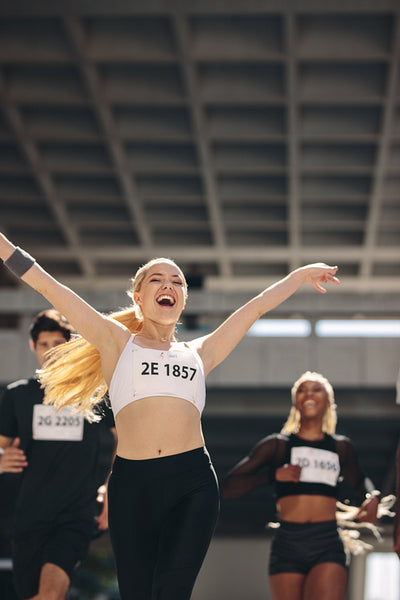 Female runner celebrating victory in marathon