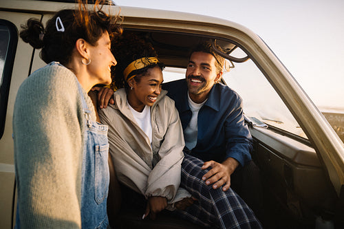 Friends enjoy a road trip in a sunny van sharing smiles and laughter