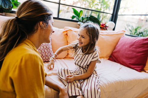 Mother and daughter share a joyful moment at home