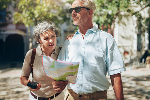 Mature couple using a map on a vacation