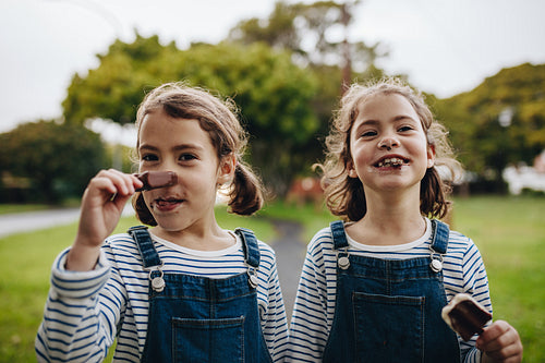 Little girls with a dirty mouth while eating ice cream