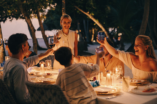 Family toasting at a serene Maldives resort dinner celebration