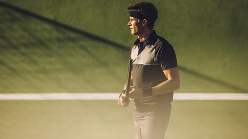 Tennis player playing on a hard court