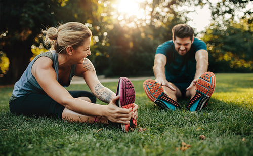 Young caucasian couple exercising in park