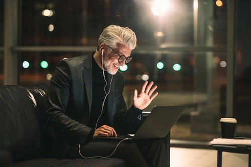 Mature businessman making video call