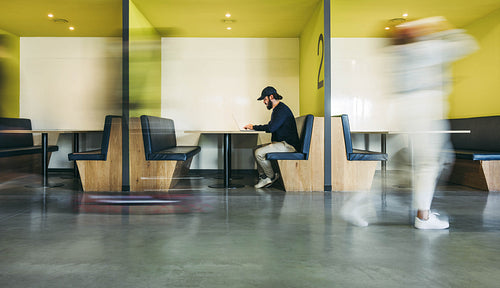 Focused business professional working in a busy office coworking office