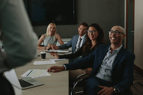 Business people smiling during meeting in board room