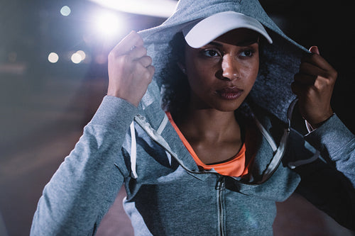 Urban runner standing on the street at night