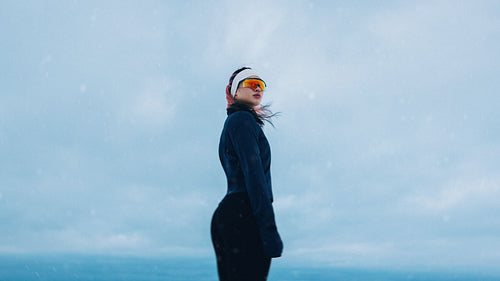 Woman portrait in winter snow wearing sportswear outdoors