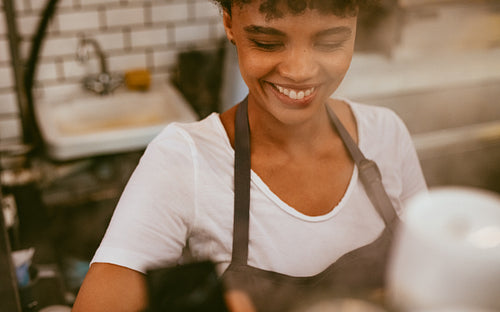 Female barista making coffee