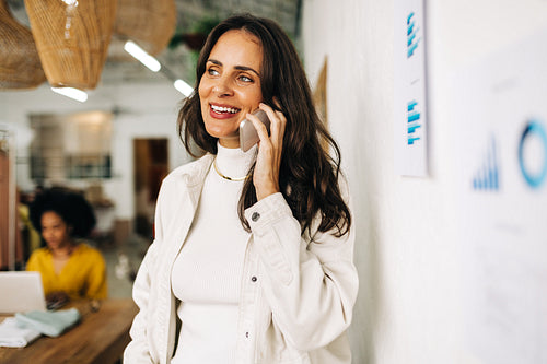 Fashion designer reaching out to her business associates with a phone call