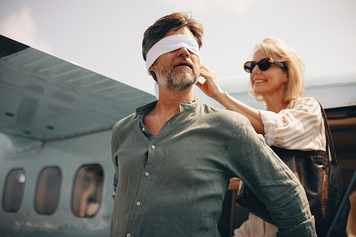 Playful couple arriving for tropical adventure by private seaplane