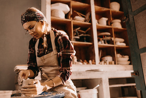 Female potter in pottery workshop