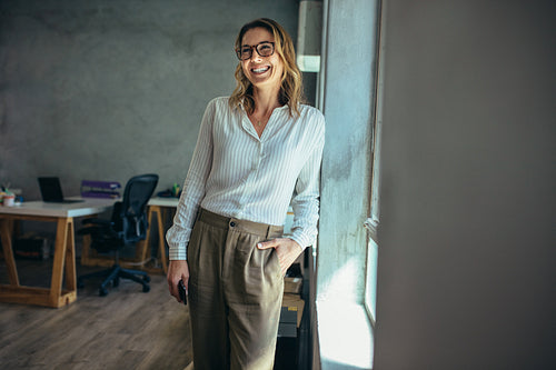 Smiling businesswoman standing in office