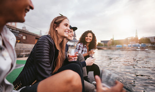 Happy young people relaxing by the lake