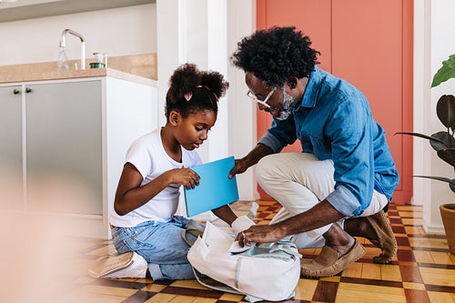 Cheerful black family at home, enjoying quality time together.