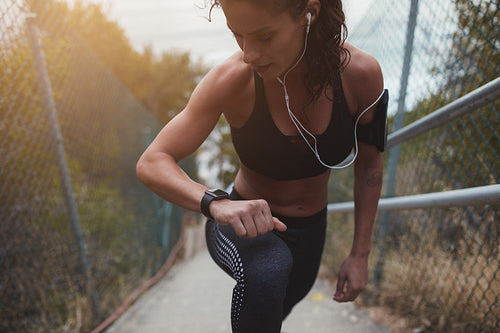  Female runner on stairs to monitor her progress