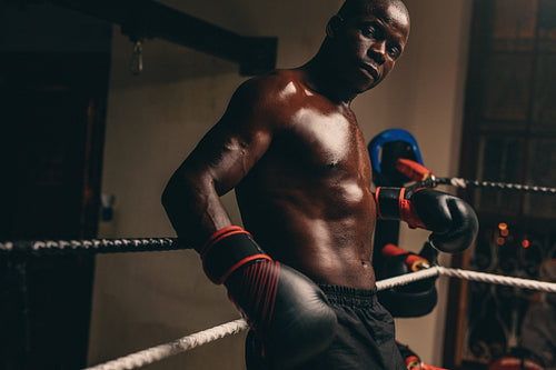Male boxer resting in his corner of the ring