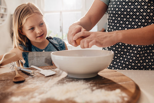 Mother and daughter preparing dough for baking