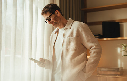 Businessman staying connected on smartphone at work