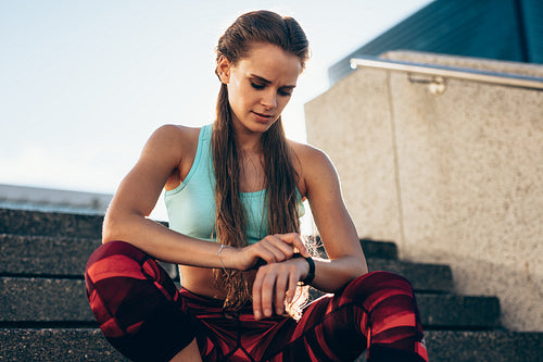 Woman checking fitness app in her smartwatch