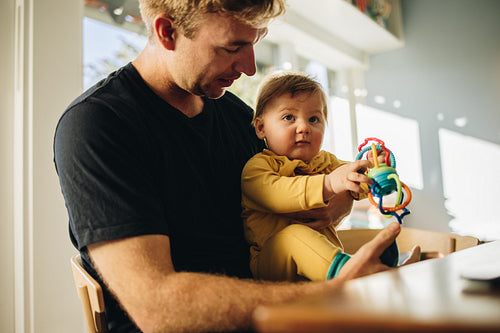 Man spending quality time with his adorable child at home