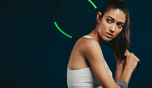 Fit young woman playing tennis